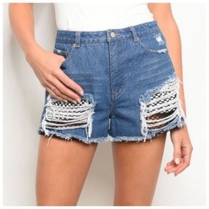 Distressed denim fishnet shorts